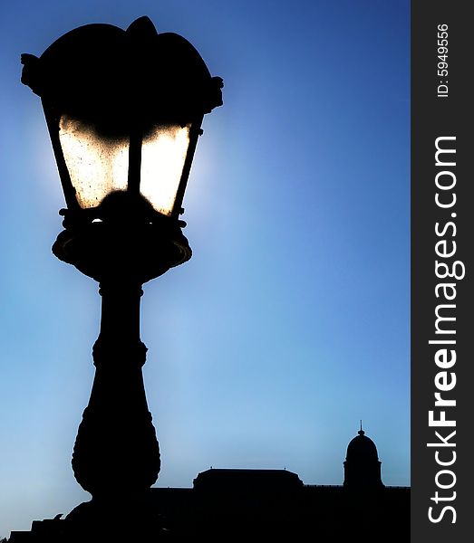 The image shows a lantern with a castle in the background. The image shows a lantern with a castle in the background.