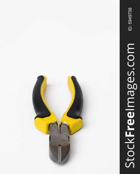 Wire cutter with yellow and black handle against white background. Wire cutter with yellow and black handle against white background