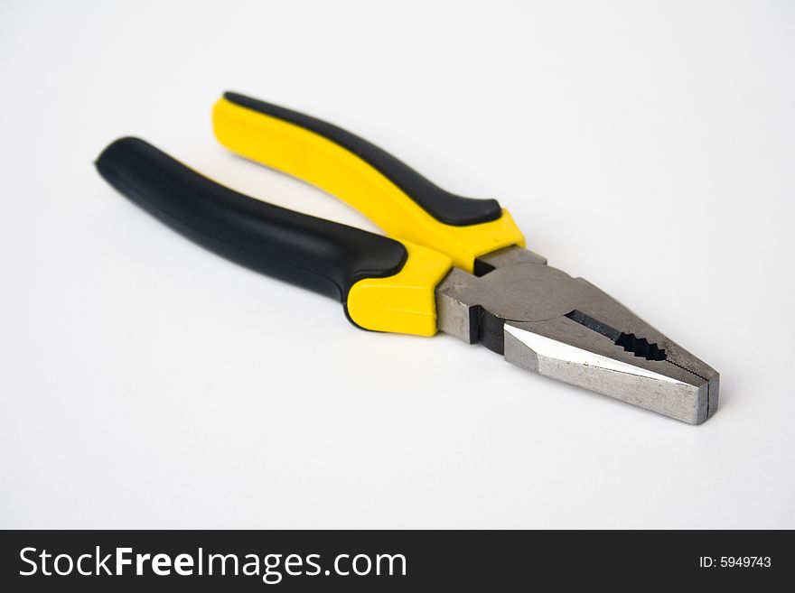 Yellow and black handled blunt nosed pliers on white background