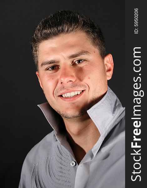 Male model in studio against black background