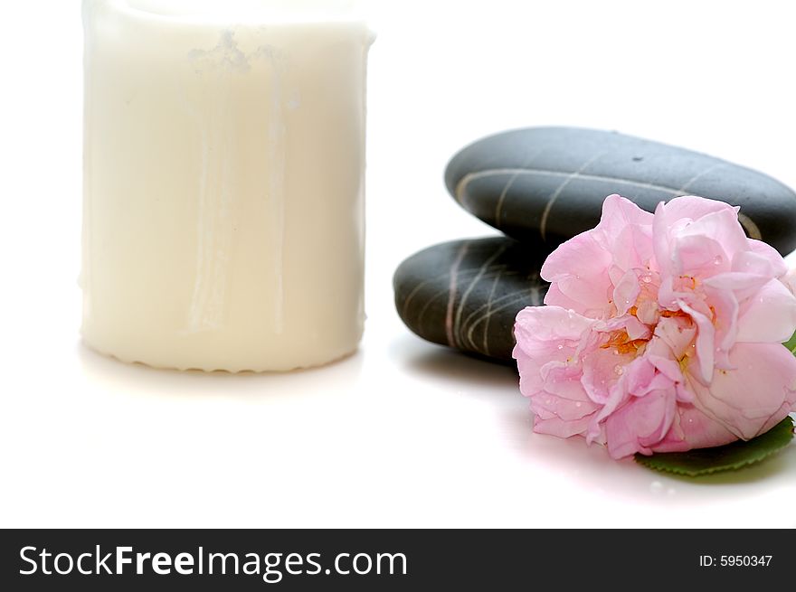 Spa stones with candle and flower