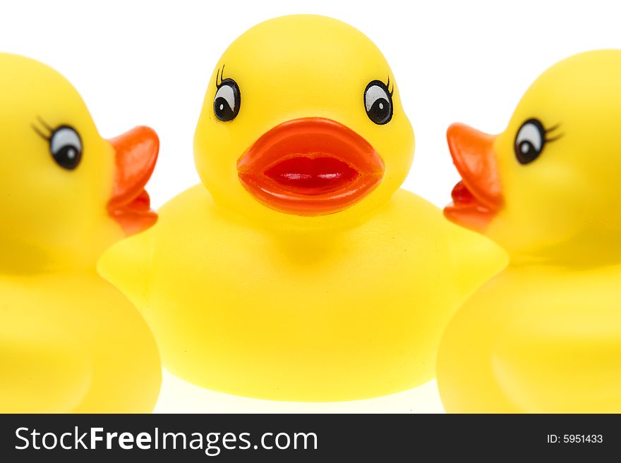 Small yellow plastic ducks isolated on a white background