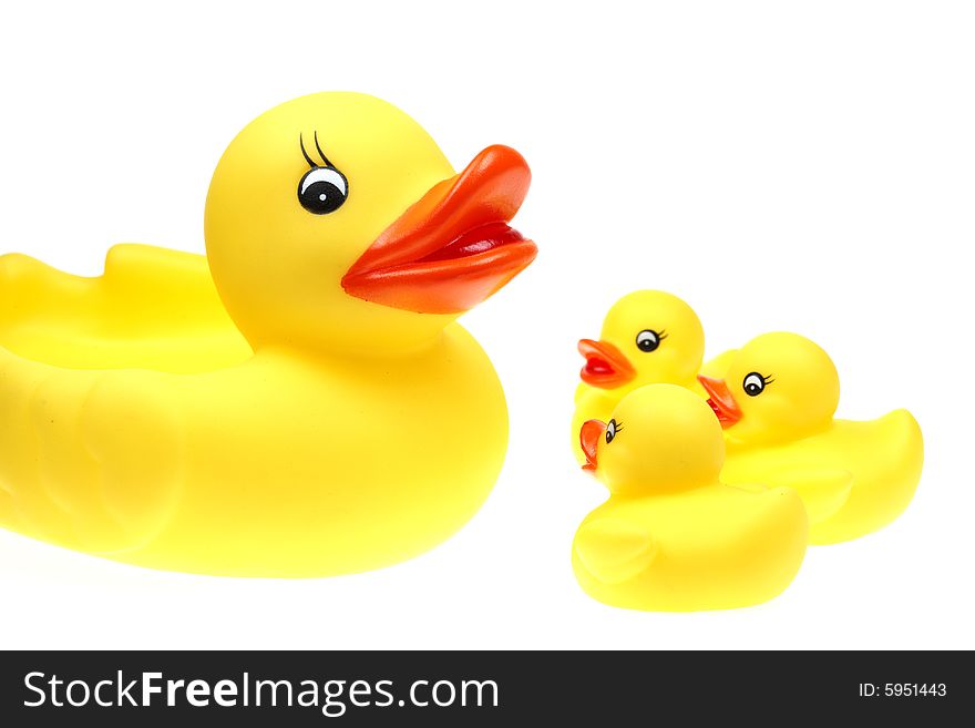 Small yellow plastic ducks isolated on a white background