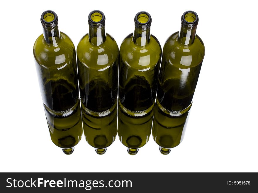Four wine bottles on a mirror