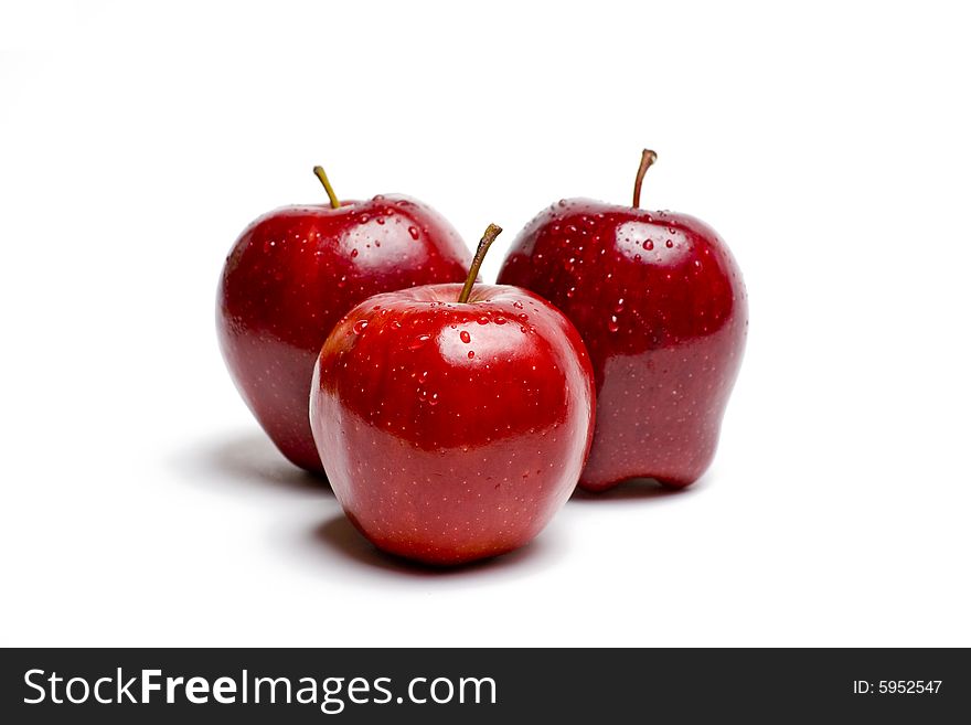 Red apples glistening with water isolated on white. Red apples glistening with water isolated on white