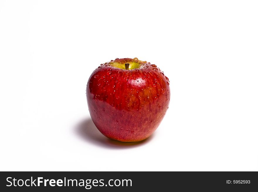 Red apple glistening with water isolated on white. Red apple glistening with water isolated on white