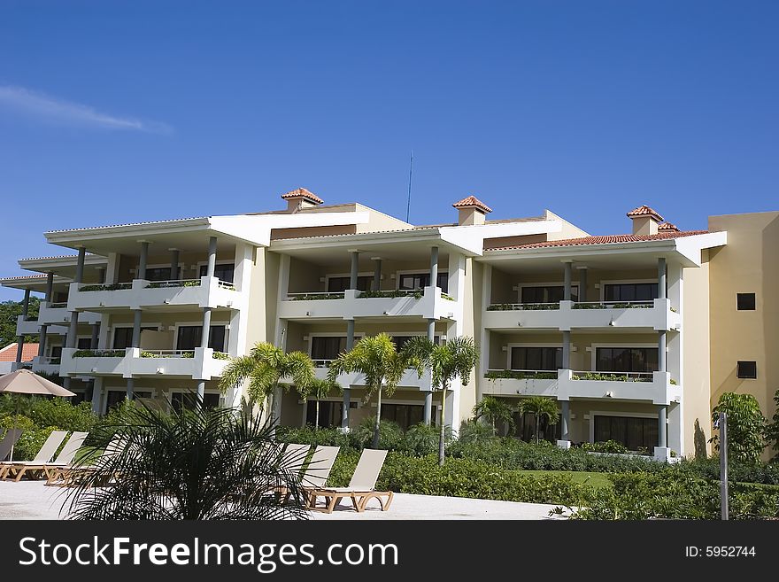 A tropical rsort building against a blue sky. A tropical rsort building against a blue sky