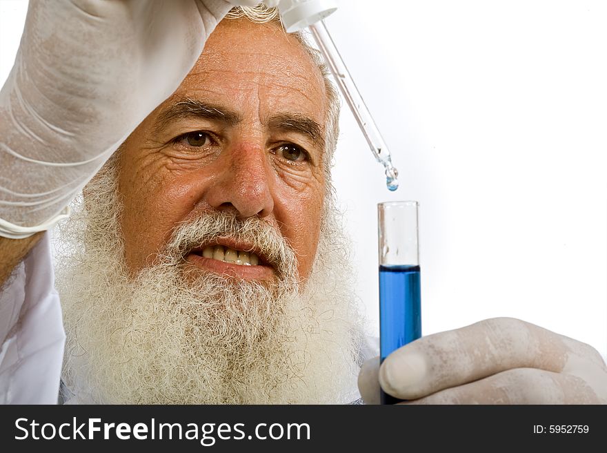 Mature scientist in laboratory holding pipette and test tube with blue liquid isolated on white