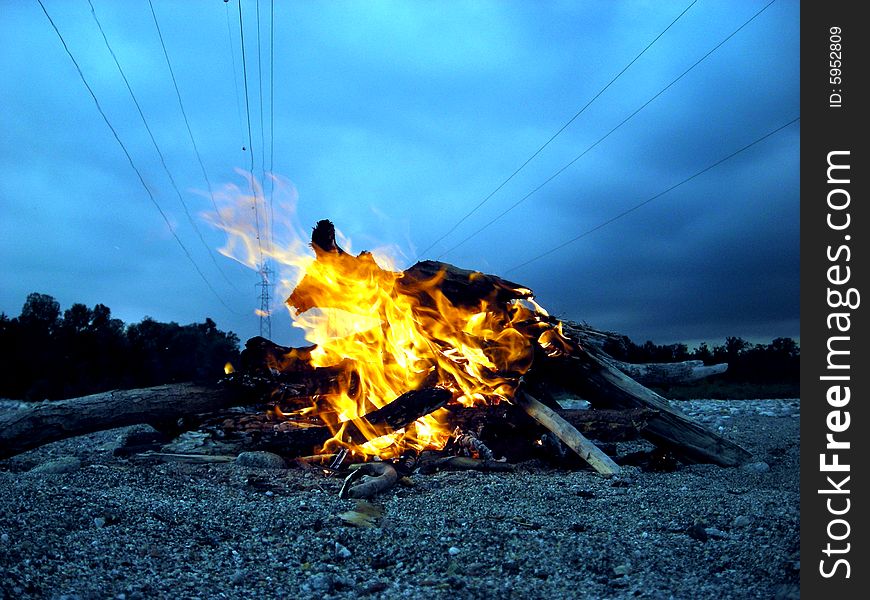 A fire near a river landscape