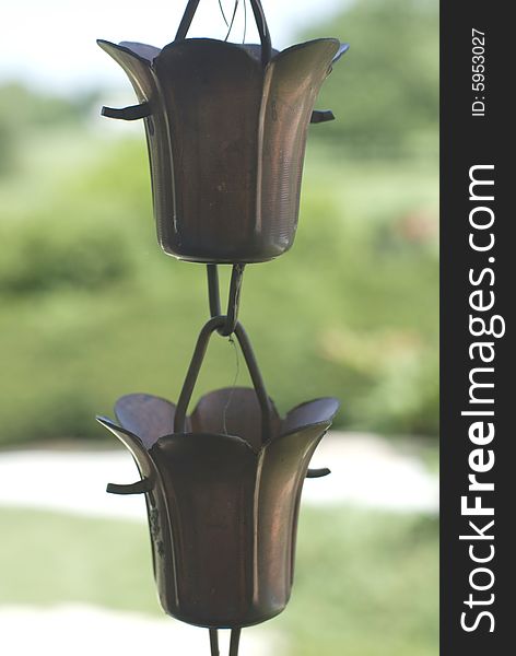 Two bronze hanging vases shaped like tulips. Two bronze hanging vases shaped like tulips.