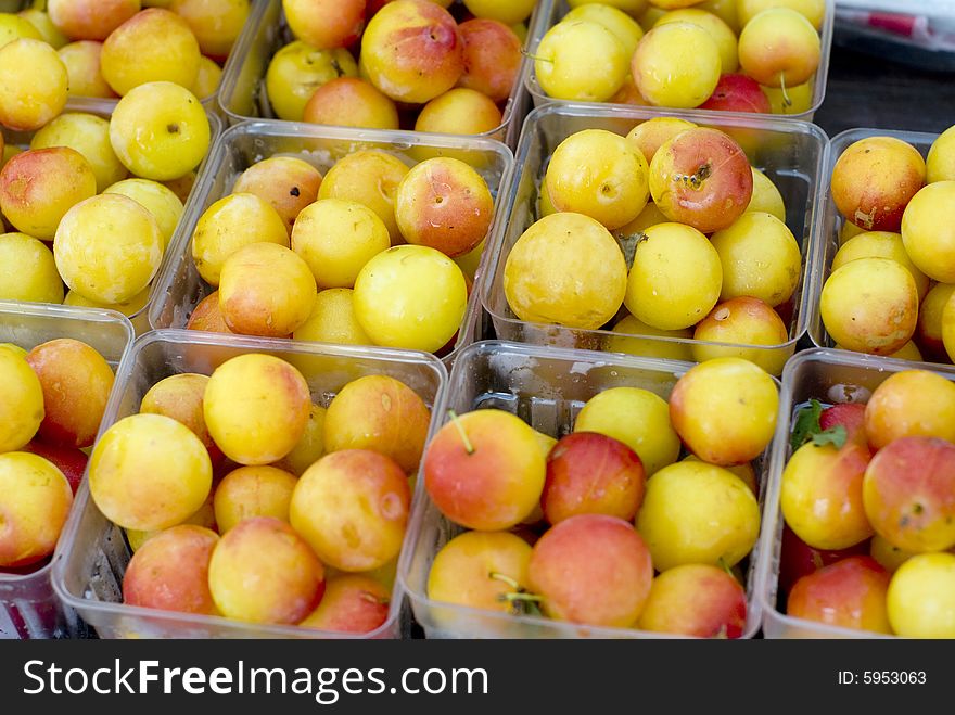 Close up shot of yellow and red Rainier cherries in clear plastic containers. Close up shot of yellow and red Rainier cherries in clear plastic containers.