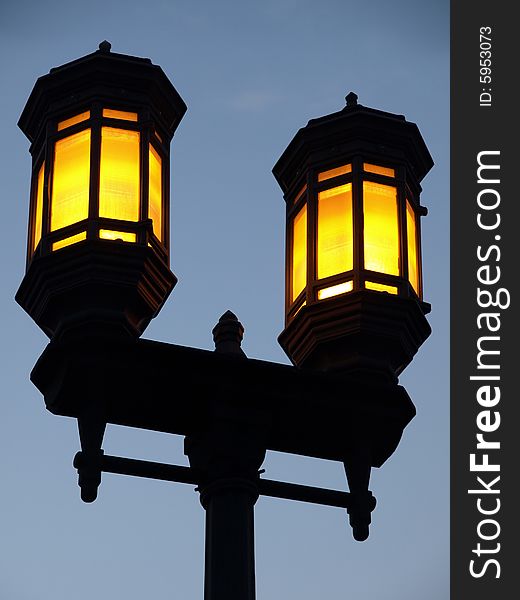Dual Yellow Lamp Streetlight against blue sky. Dual Yellow Lamp Streetlight against blue sky