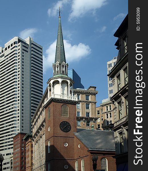 Historic Brick Church and Modern Buildings blue sky
