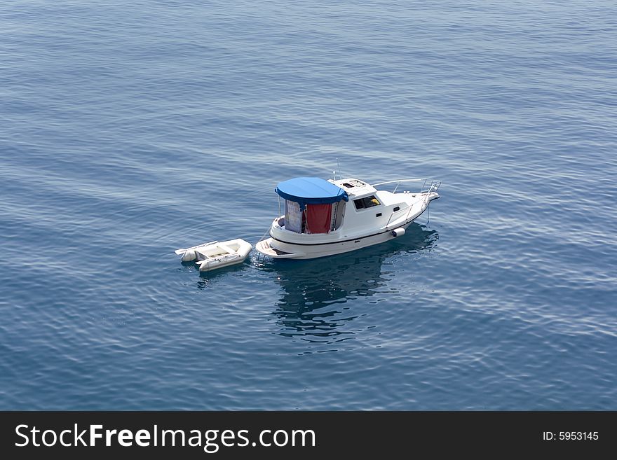 Small boat in blue sea