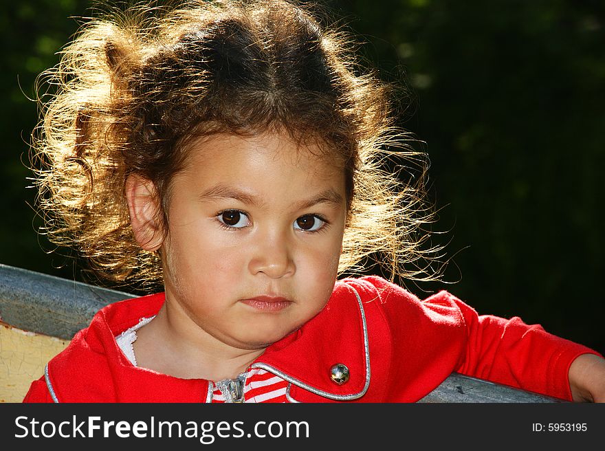 The Portrait pensive child with hair illuminated sun.