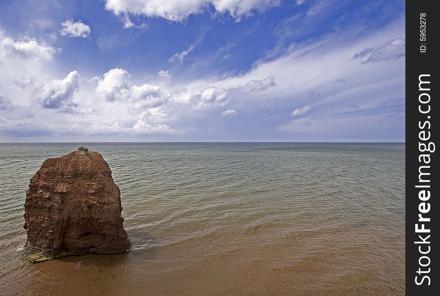Sandstone pillar of rock on the North Shore of Prince Edward Island which is a typical formation for the island.