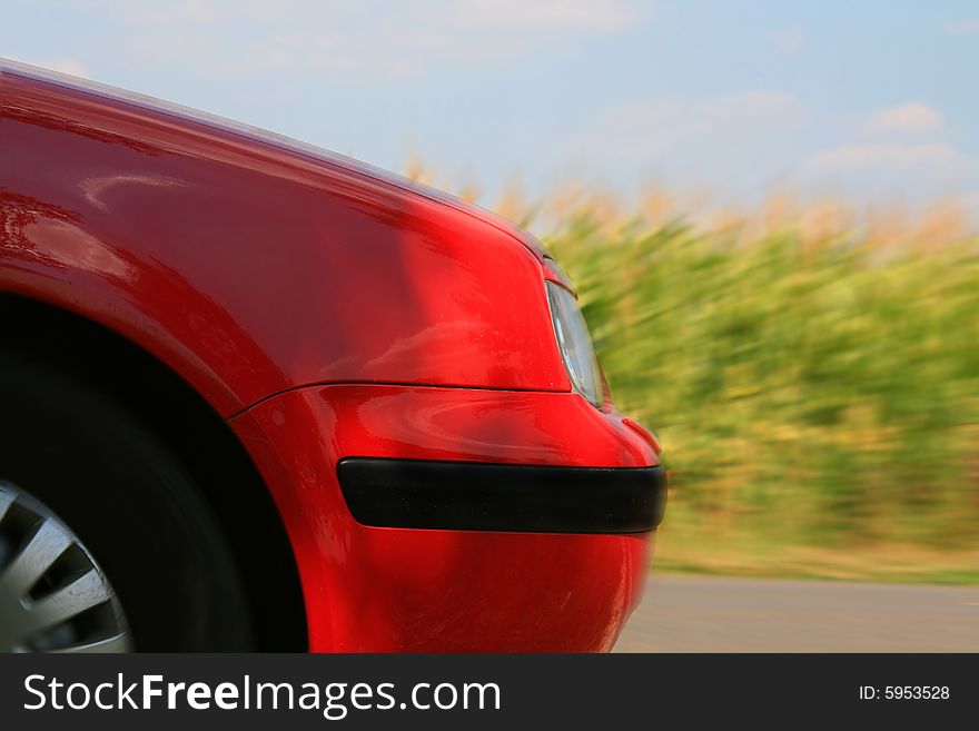 Speeding red car - corn fields