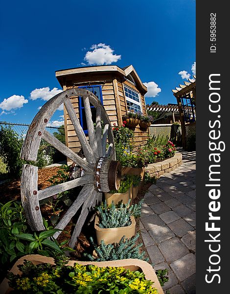 A beautiful backyard with shed and wagon wheel. A beautiful backyard with shed and wagon wheel