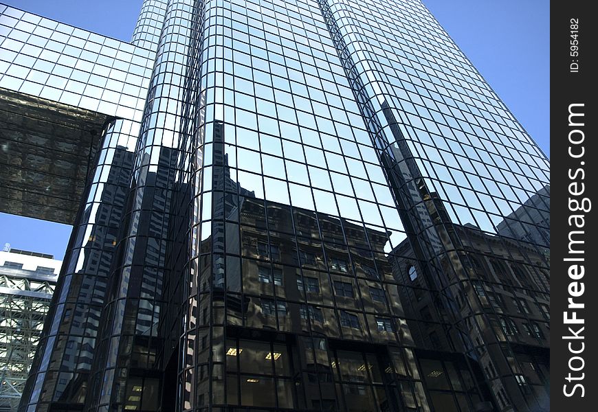 Glass Towering Skyscraper Perspective against blue sky. Glass Towering Skyscraper Perspective against blue sky