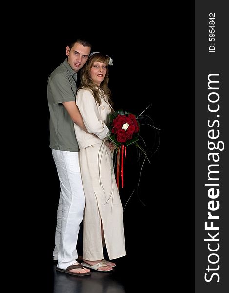 Young happy laughing wedding couple on black background, studio shot. Young happy laughing wedding couple on black background, studio shot