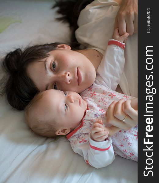 Baby with mom in the bed