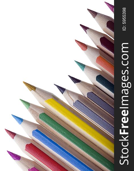 Row of colored pencils isolated against white background leaving copyspace