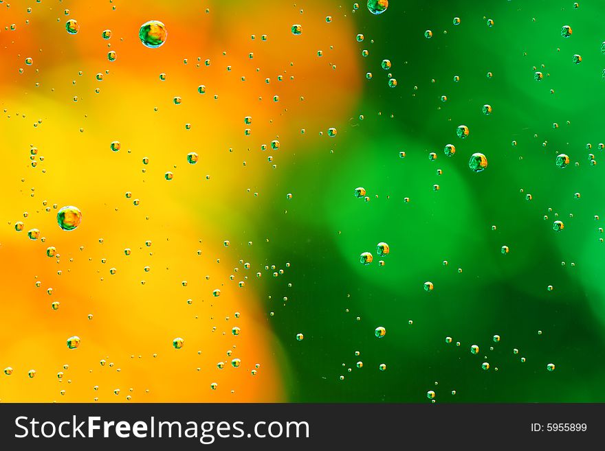 Drops of water on a green, yellow background. Drops of water on a green, yellow background.