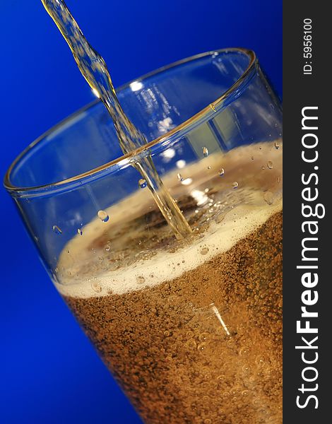 Glass of beer on blue background. Glass of beer on blue background.