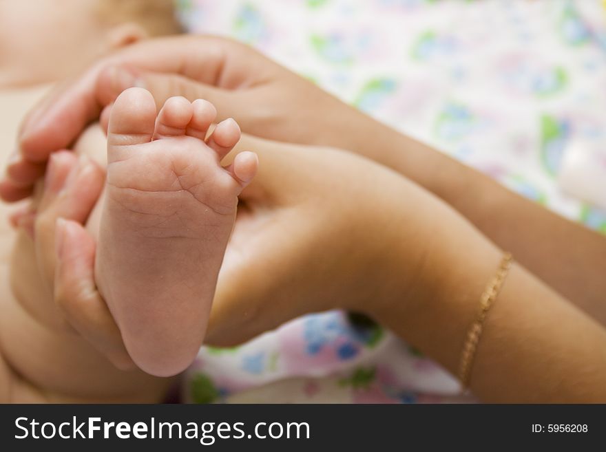 Little baby foot in mothers hands