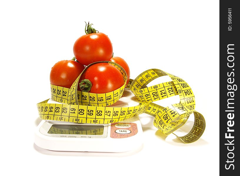 Ripe juicy tomato and tape measure isolated