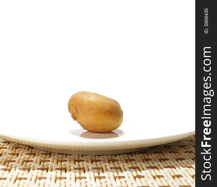 Potato on a plate isolated on a white background. Potato on a plate isolated on a white background