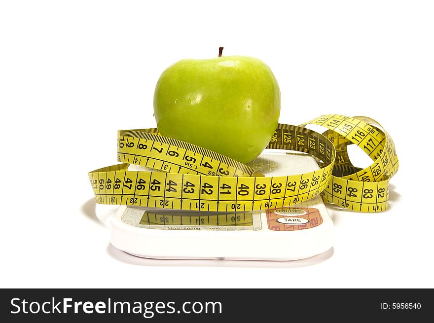 Green apple, scale and tape measure isolated. Green apple, scale and tape measure isolated