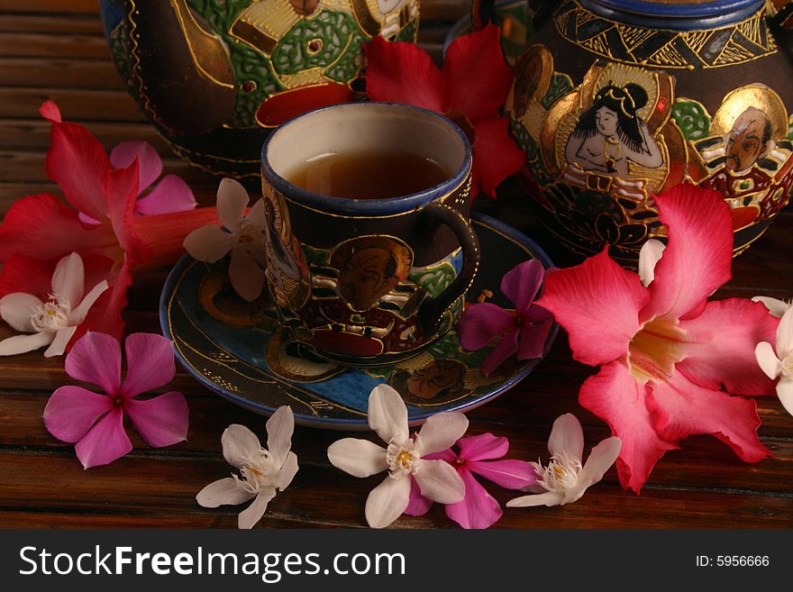 Tea set with tea and flowers