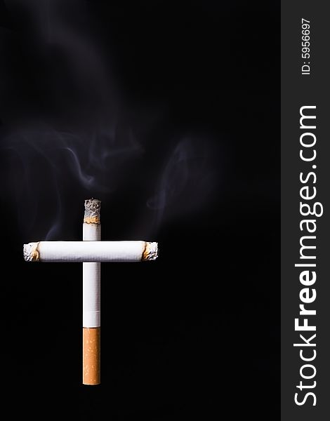 Cigarette cross against a black background