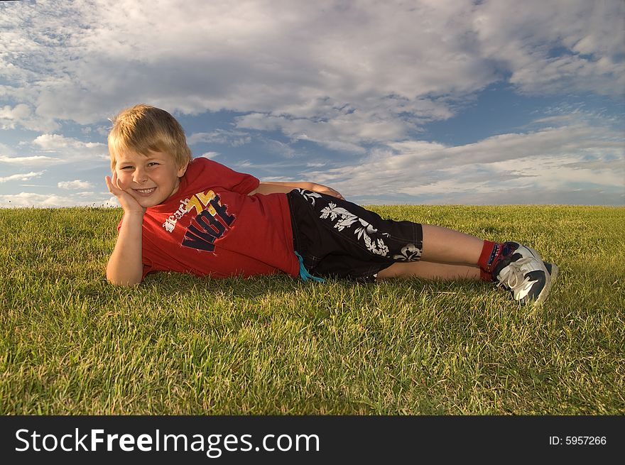 A Smiling happy boy (5 year old) taken against a sunny background. A Smiling happy boy (5 year old) taken against a sunny background