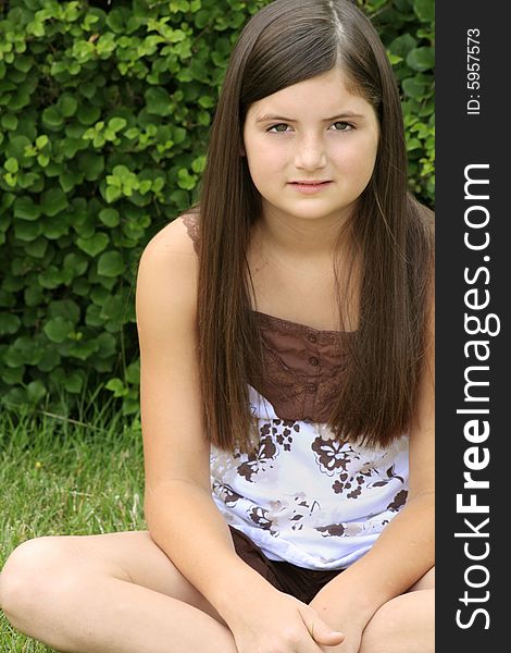 Beautiful brunette girl sitting in the park. Beautiful brunette girl sitting in the park