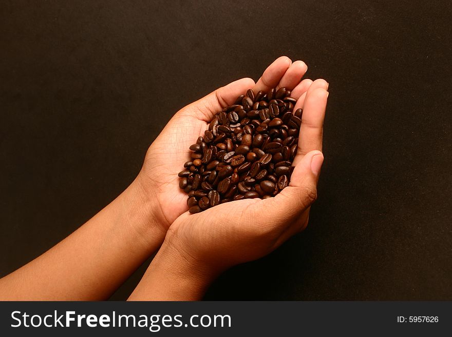 A hand with coffee beans