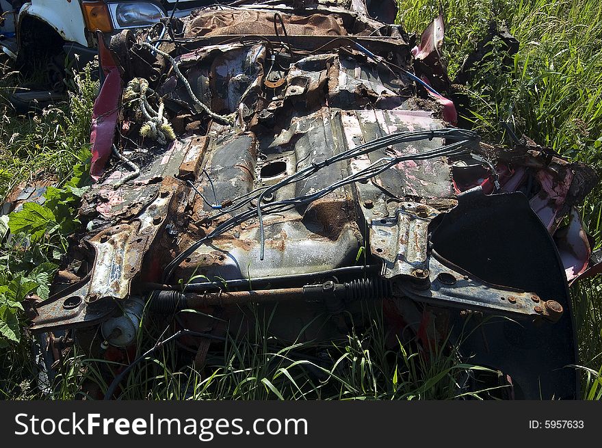 Bottom of crushed car, by the Road in a scarp yard,
Car crushers are compactors and can be of several types: one is a &#x22;pancake&#x22;, where a scrap automobile is flattened by a huge descending hydraulically powered plate, or a baling press type, with which the automobile is compressed from several directions until it resembles a large cube. A third type is a mobile crusher. Bottom of crushed car, by the Road in a scarp yard,
Car crushers are compactors and can be of several types: one is a &#x22;pancake&#x22;, where a scrap automobile is flattened by a huge descending hydraulically powered plate, or a baling press type, with which the automobile is compressed from several directions until it resembles a large cube. A third type is a mobile crusher.