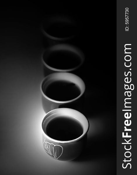 Cup of tea with nice pattern on dark background. Cup of tea with nice pattern on dark background