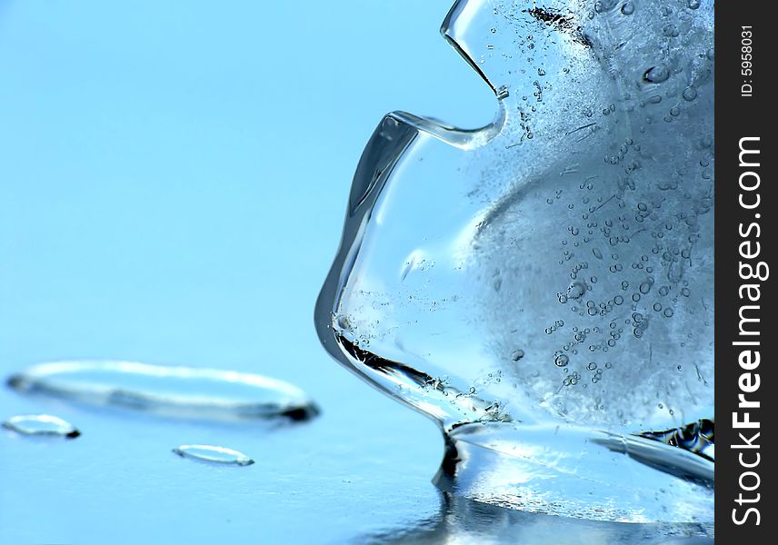 Ice cube on mirror as background. Ice cube on mirror as background