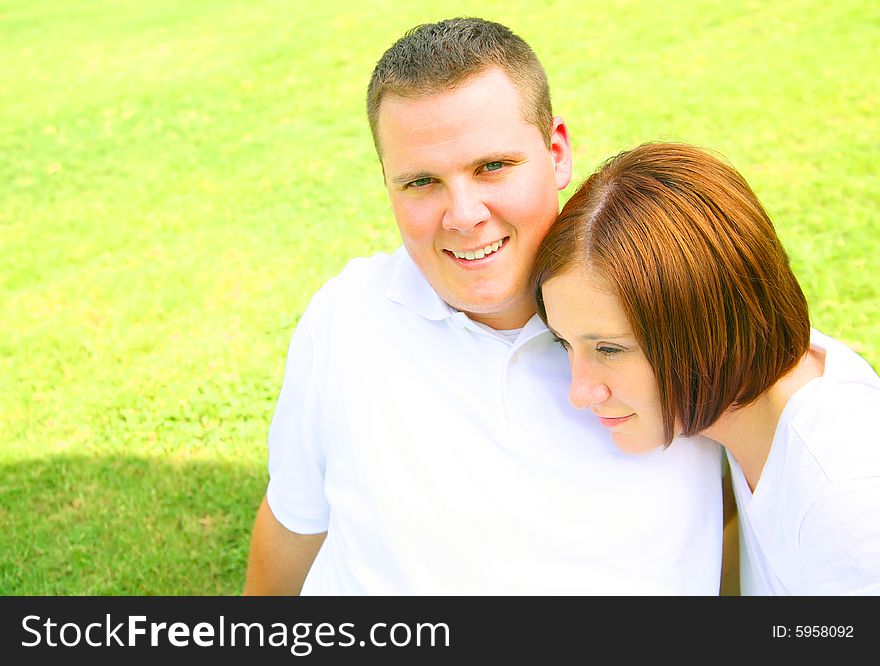 Happy couple embracing and playing in the park. concept for family and young people. Happy couple embracing and playing in the park. concept for family and young people