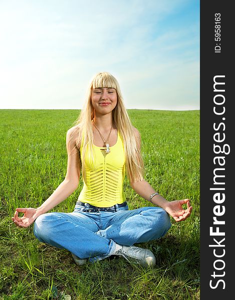 Woman in field hold hand palm up under blue sky and clouds