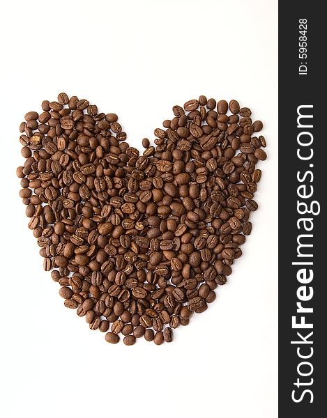 Coffee beans as heart on white background