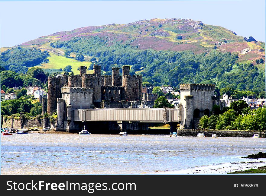 Conway castle across estuary with hills and skyin background. room for text. Conway castle across estuary with hills and skyin background. room for text