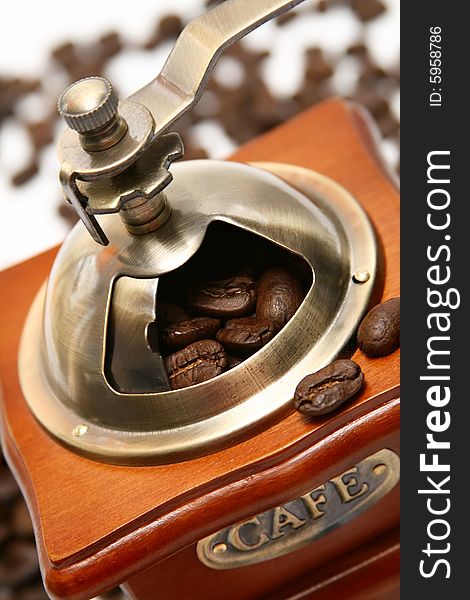 Old-fashioned coffee grinder with coffee beans