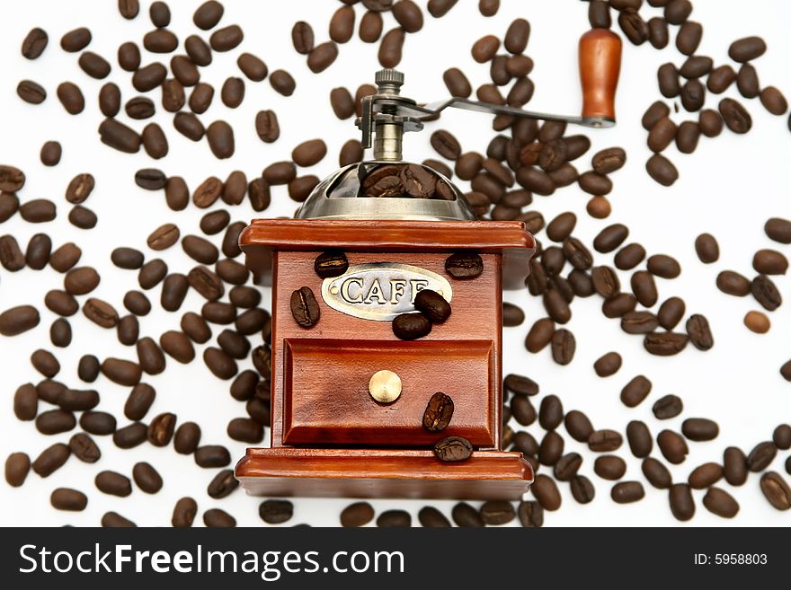 Old-fashioned coffee grinder with coffee beans