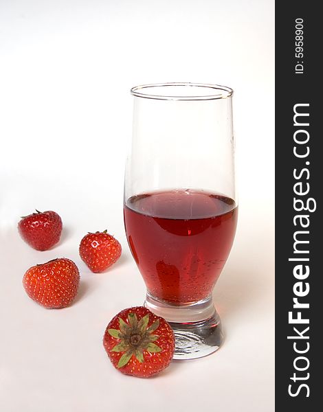 Red champagne in a glass with strawberries, isolated on white