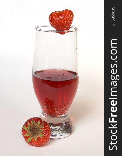 Red champagne in a glass with strawberries, isolated on white