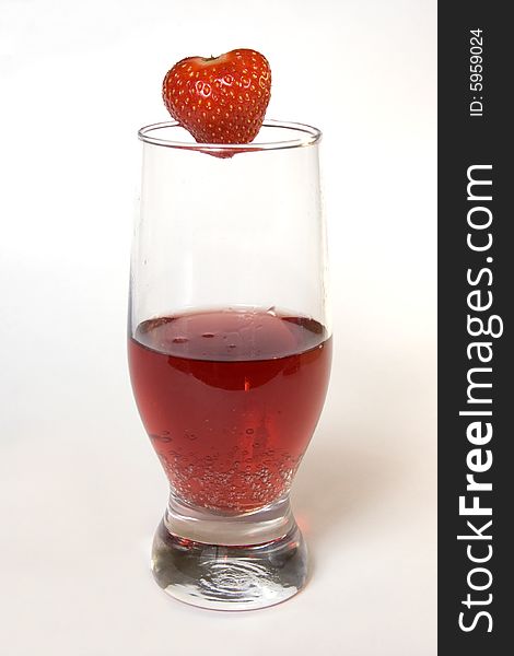 Red champagne in a glass with strawberry, isolated on white