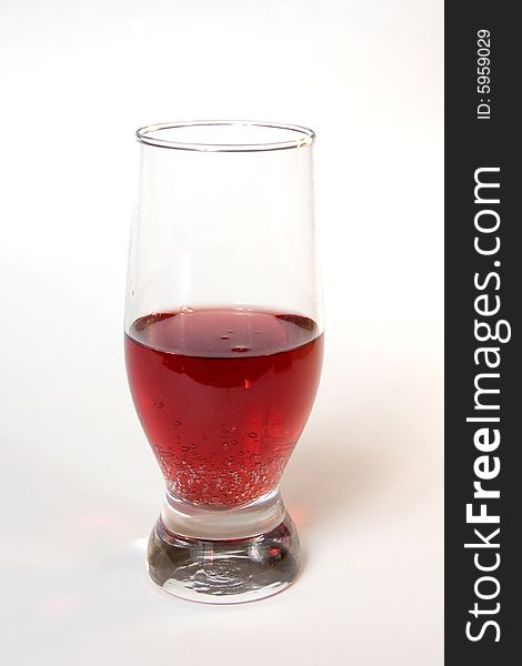 Red champagne in a glass, isolated on white